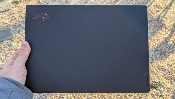 Lenovo ThinkPad X1 Nano viewed from the top, lid closed, held with two fingers