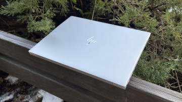 Silver HP Envy 14 closed on wooden gazebo