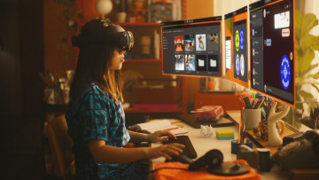 Girl wearing Meta Quest Pro headset and working on three virtual screens