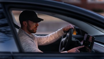 Man inside a Tesla car